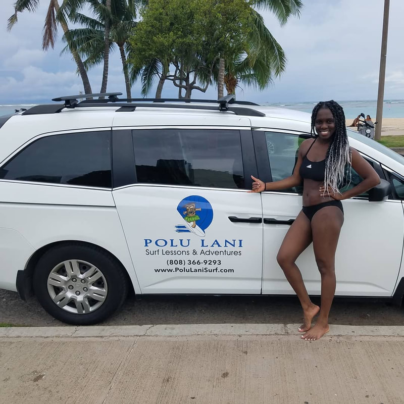 A lady throwing the shaka in front of the Polu Lani Surf van. Provided by Polu Lani Surf.